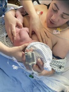 Midwife helping new mum to breastfeed