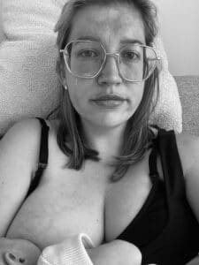 Megan breastfeeding daughter at home